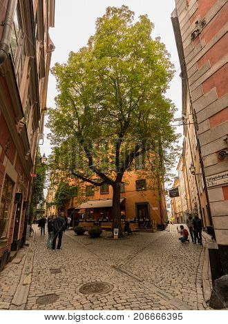 STOCKHOLM, SWEDEN - SEPTEMBER 9: Tourists in Tyska Brunnsplan square in Gamla Stan on September 9, 2017 in Stockholm, Sweden. The square was first mentioned in 1649