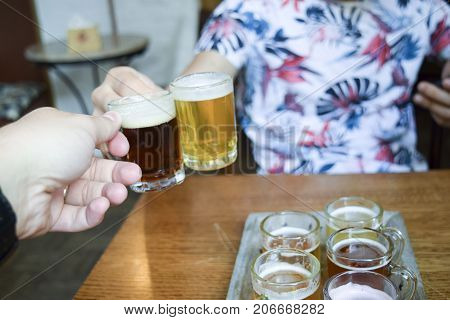 Two Men Toasting (cheers!) Over Mini Beer
