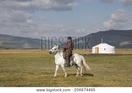 Huvsgul Mongolia September 6th 2017: mongolian man riding a horse in northern mongolian landscape
