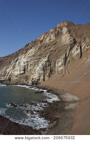 Anzota Caves at Arica on the coast of Chile. The area was used as a settlement by the Chinchorro people and later mined for guano deposited on the cliffs.