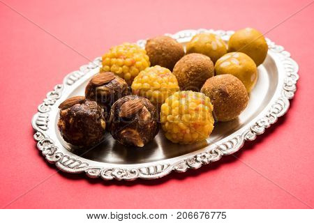 Stock photo of variety of sweet laddu or laddoo or ladu, a sweet dumpling made up of bundi, dry fruits or rava, selective focus