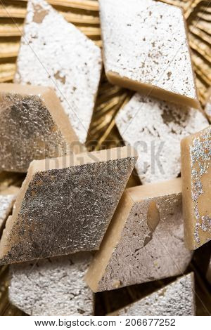Stock photo of Kaju Katli, a popular indian sweet burfi made using milk, khoya, cachew and Sugar