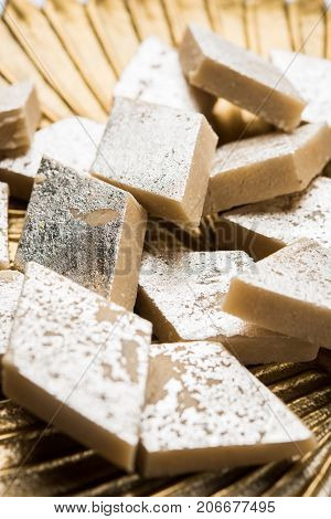Stock photo of Kaju Katli, a popular indian sweet burfi made using milk, khoya, cachew and Sugar
