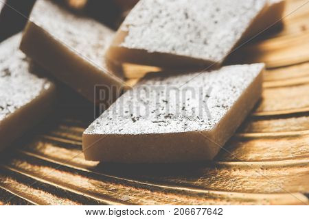 Stock photo of Kaju Katli, a popular indian sweet burfi made using milk, khoya, cachew and Sugar