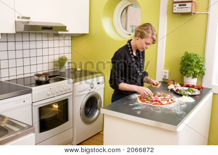 Unge kvindelige Making Pizza