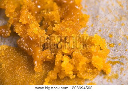 Abstract background of cannabis concentrate live resin macro detail extracted from medical marijuana