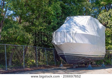 white shrink wrap on power boat on stands