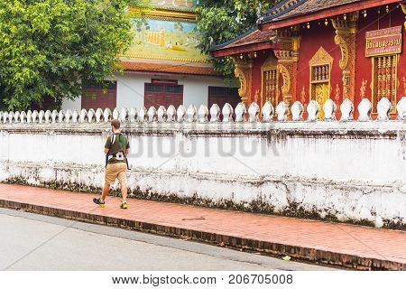 Man near the temple Wat Sensukaram in Louangphabang Laos. Copy space for text
