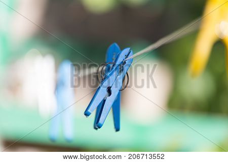 clothespin on a clothesline . In the park in nature