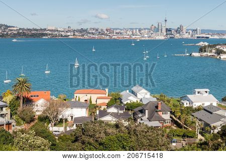 houses in Devonport suburb with Auckland CBD in background
