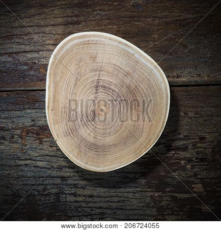 Wood plate on wood background top view