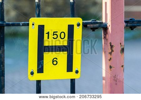 Closeup view Underground electric line cable sign.