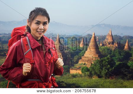 Asian lady backpacker walk in Bagan with ancent pagoda and mountain Bagan Myanmar