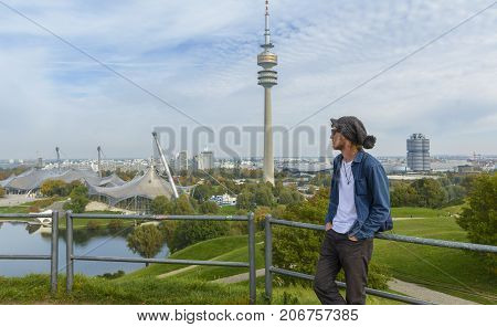 Young tourist admiring the sights of Olympiapark on September 30 2017 in Munich Bavaria Germany.
