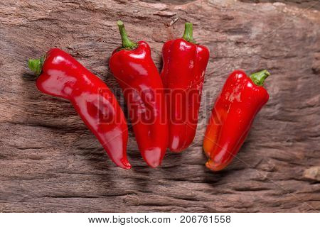 Red Chilly Pepper On Wooden Black Background. Red Hot Chili Peppers.