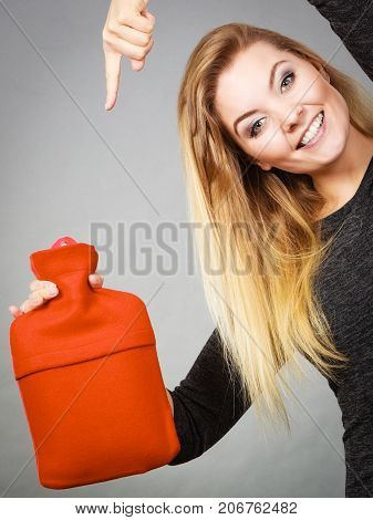 Woman Holding Warm Red Hot Water Bottle