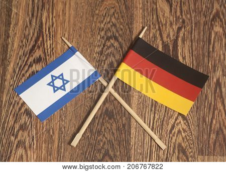 Germany end Israel Flag on wooden background