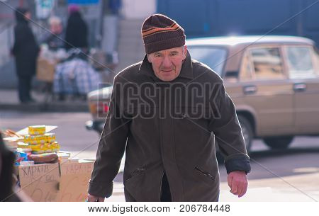 Zhytomyr Ukraine - November 05 2015: lonely senior walking at park old man got lost