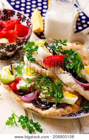 pita sabich sandwich with hummus and vegetables..selective focus