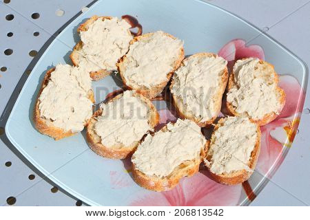 Mackerel rillettes on slice of French baguette on a plate