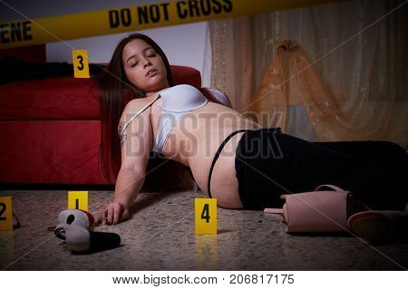 young brunette woman lying dead  after rape