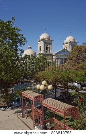 Historic church of San Andres on the edge of the Plaza in the village of Pica in the Atacama Desert, Tarapaca, Chile.