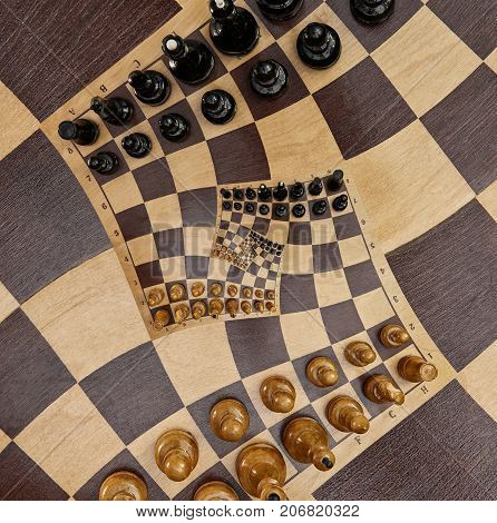 Abstract wooden chess desk white black figures square spiral effect. Chess wooden board abstract spiral fractal Surreal chess board figures spiral background pattern incredible fractal effect Chess game
