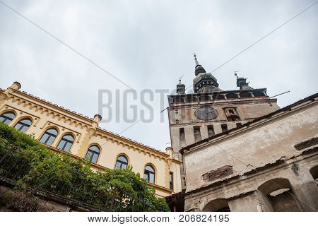 Sighisoara Clock Tower (Turnul cu Ceas) during a cloudy fall afternoon. It is the main entrance of Sighisoara castle in Romania birthplace of Vlad Tepes aka Dracula