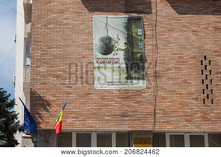 DROBETA TURNU SEVERIN ROMANIA - SEPTEMBER 22 2017: Anti Corruption poster displayed on a state administration HQ wall in Turnu Severin Transylvania. Romania is considered to be one of the most corrupt countries of the European Union