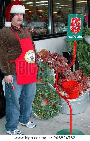 DECEMBER 4, 2004. SEATTLE, WA. CIRCA:  Male bell ringer with the salvation army asking for donation during the xmas holiday season.