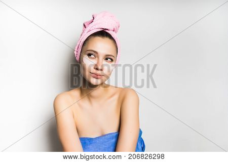 pensive beautiful girl came out after shower, isolated