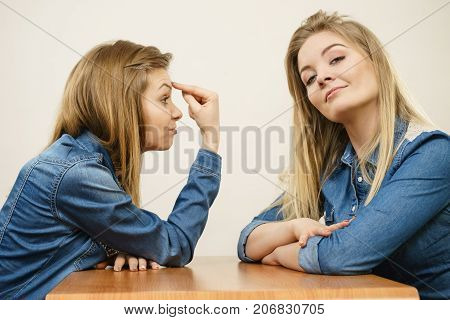 Woman Mocking Her Confident Friend