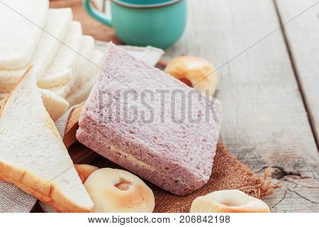 Bread of cream and more on wooden table.