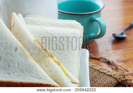 Ham bread and coffee cup on table.