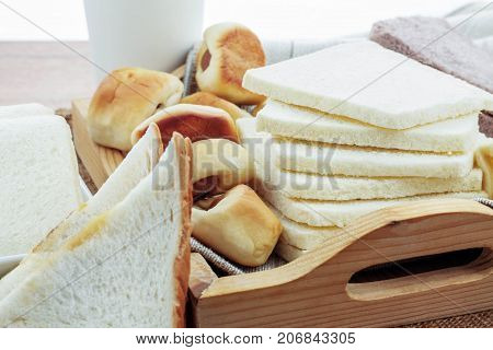 Many Breads And Cups Of Coffee On The Table.