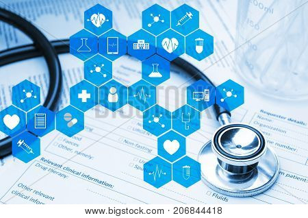 stethoscope test tube beaker and medical information form on desk with medical icon in hexagon pattern blue color tone laboratory science chemical and medical research concept