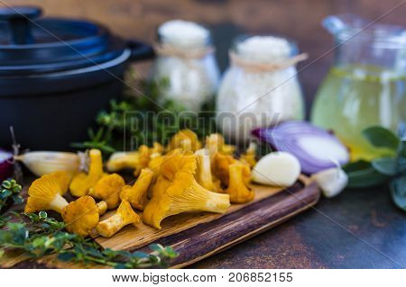 Ingredients for preparing risotto, Italian food. Fresh chanterelle mushrooms with arborio and herbs.