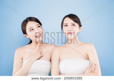 two beauty woman look somewhere with healthy skin care on the blue background