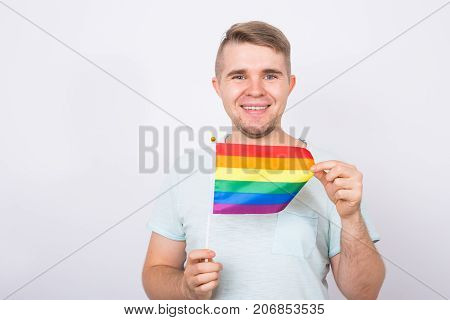 Young man hold a rainbow flag, gey boy.