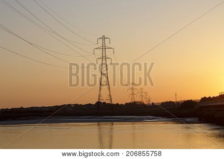 Save
Download Preview
Electricity pylon silhouetted against a sunset sky background.