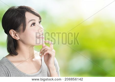 woman look somewhere on the green background