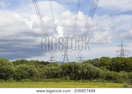 Electricity pylons crossing the Welsh countryside in a horizontal format