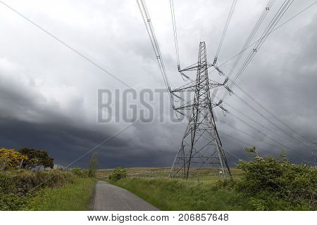 One electricity plyon in the Welsh countryside. The cables are crossing the land to the next plyon.