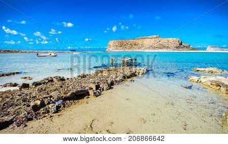 Amazing view of Balos Lagoon with magical turquoise waters, lagoons, tropical beaches of pure white sand and Gramvousa island on Crete, Greece
