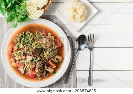 Thai Spicy Papaya Salad With Pork Sausage, Salted Crab, Scald Snail And Sticky Rice On Top View: Pop
