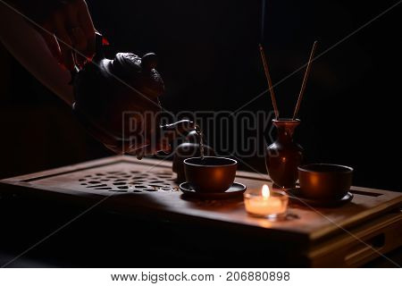 Tea ceremony with candles in the evening