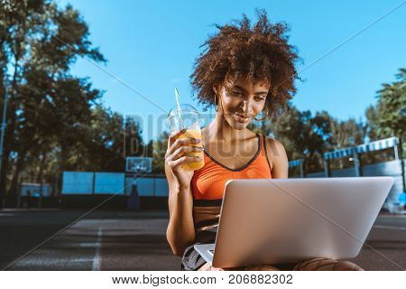 African-american Woman With Laptop And Juice