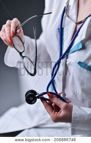 A stethoscope in the hands of the doctor