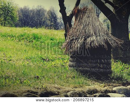 Old unique bee house made of straw.