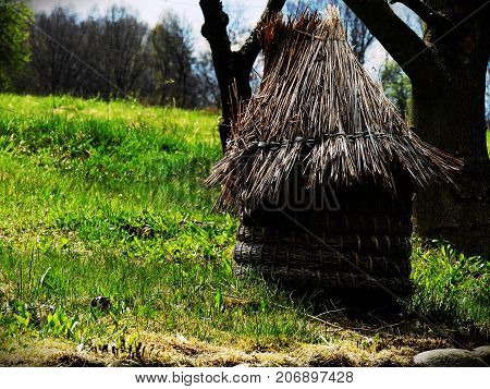Old unique bee house made of straw.